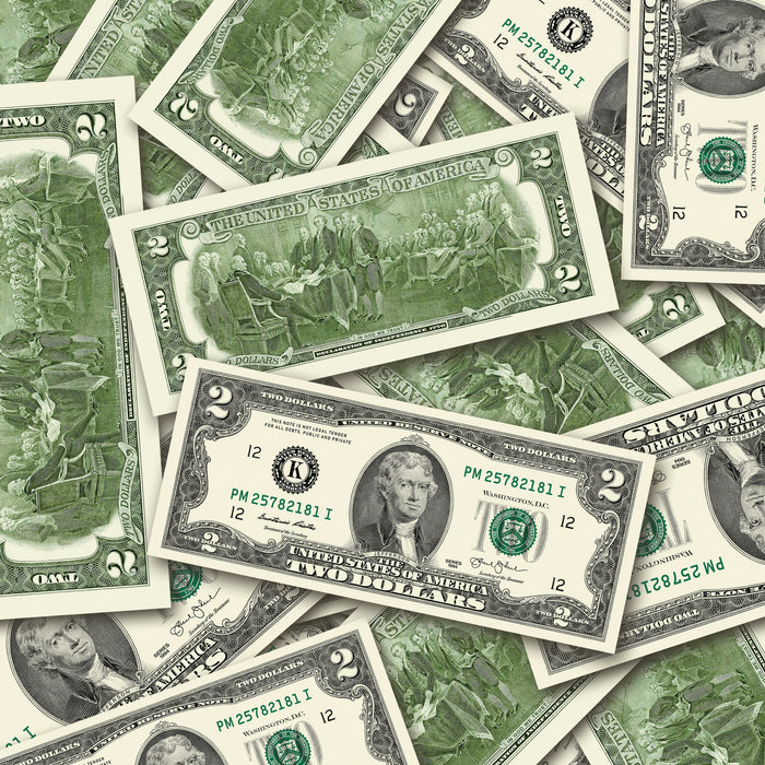 $2 1990s Close-Up prop bills with printed fronts and backs scattered randomly; one complete front and back centered.