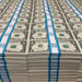 Rows of actual $1 Full Print prop money stacks wrapped in cyan $100 bands
