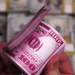 Stack of pink novelty money bills for themed events and decorations